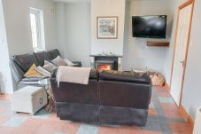 Seamount Holiday Village No. 26. Cosy living room, open fire, TV.  Seaside Holiday Home Available near Courtown Village, County Wexford