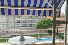 Terrace with awning overlooking the community pool