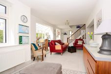 Bright living room with red sofas at Clifden Glen Holiday Village No.57 in Clifden, Co. Galway