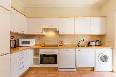 Spacious and fully equipped kitchen with dining area.