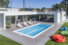 House surrounded by outdoor space, with swimming pool and garden.