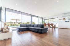 Spacious living room surrounded by large windows that give plenty of natural light to the room.