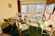 Indoor terrace with wooden tables and chairs in flat in Cala Finestrat