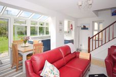 Living room area with red leather sofas at Clifden Glen Holiday Village No.57 in Clifden, Co. Galway